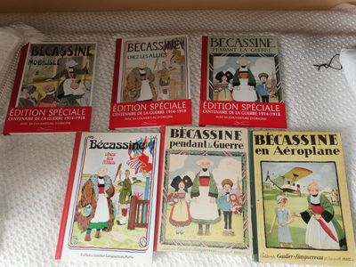 several children ' s books are lined up on a bed
