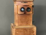a wooden box with two binoculars on top of it