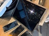 a laptop computer sitting on a table next to a bunch of other electronics