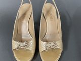 a pair of women ' s shoes with bows on the toes