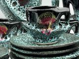many plates and cups that are sitting on a table