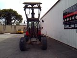 a tractor that is parked in front of a building