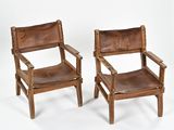pair of brown leather chairs on white background with white backdrop