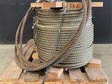 a large coil of rope sitting on top of a wooden pallet