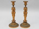 pair of antique brass candlesticks with figures on the bases