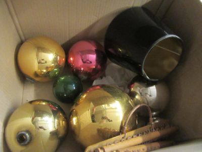 a box filled with christmas ornaments and baseball bats