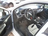 a car that is parked in a lot with its door open