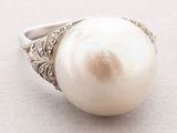 an image of a white pearl ring on a white surface