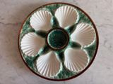 a white and green plate with shells on it