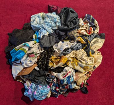 a pile of clothes that is on a red surface