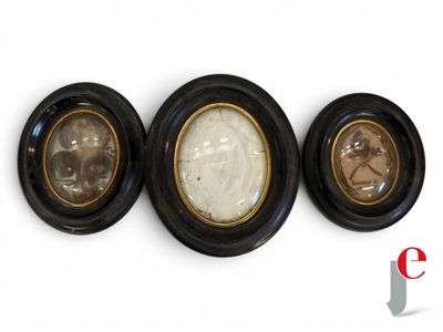 three black and gold framed pictures of a man and a woman