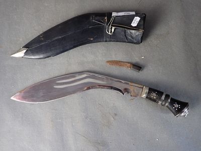 a knife that is laying on the ground next to a knife