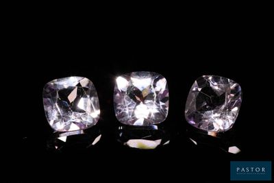 a group of three different colored diamonds on a black background