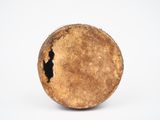 a brown object with a hole in it on a white surface