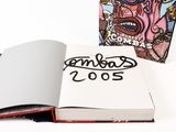 an open book with a drawing of a man on it next to a book with a picture of a man on it