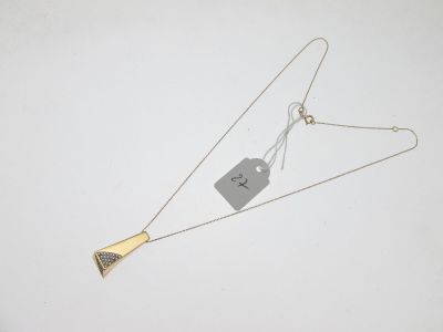 silver and gold triangle necklace with a tag attached to it