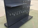 a close up of a metal shelf in a warehouse with lots of hooks