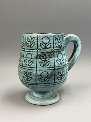a close up of a cup with a pattern on it