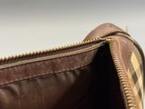 the inside of a brown purse with a zipper on it