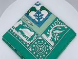 a white plate with a green and white napkin on it