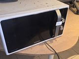 a microwave sitting on top of a table in a kitchen