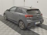 a grey car parked in a garage with a checkered floor
