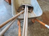 a wheelbarrow and a pair of baseball bats in a wheelbarrow