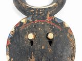 an image of a wooden mask with horns on a white background