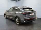 the rear end of a grey volkswagen suv parked in a garage