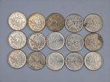 several different types of coins are arranged in a row on a blue surface
