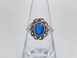 a close up of a ring with a blue stone in it