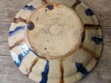 a blue and white plate sitting on a wooden table