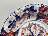 a blue and red plate with a peacock design on it
