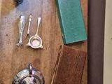a wooden table with silverware and a book on it