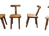 three wooden chairs sitting next to each other on a white surface