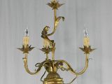 a figurine of a woman holding a candelier with candles on it