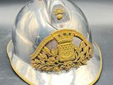 a silver helmet with a gold emblem on it