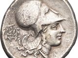 a silver coin with an image of a woman wearing a hat