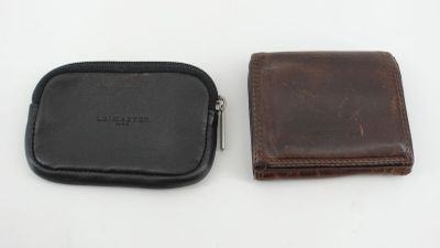 un gros plan d'un portefeuille et d'un étui à portefeuille posés sur une surface blanche