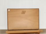 a wooden easel with a piece of wood on top of it