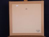 a painting on a easel with a piece of paper on it
