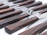 many knives that are lined up on a table