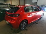 the rear end of a red car parked in a garage