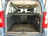 the back of a blue van with its trunk open and the back seats down
