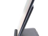 a cell phone that is on a stand on a white surface