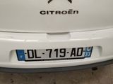 a close up of a white car with a star on the back of it