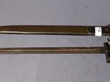 pair of antique brass plated knifes on a white surface
