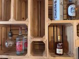 a wooden wine rack with bottles and bottles on top of it