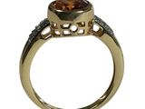 an image of a gold ring with a large brown diamond