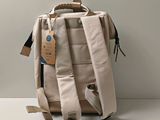 a backpack with a tag on it sitting on a table
